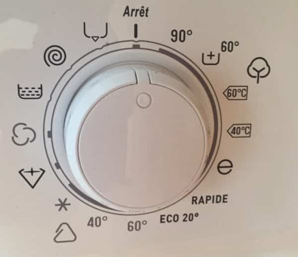 Many strange icons on a washing machine. Photo.