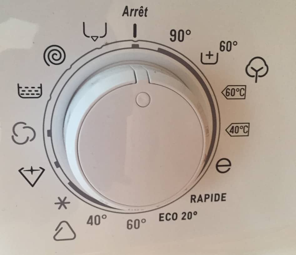 Many strange icons on a washing machine. Photo.