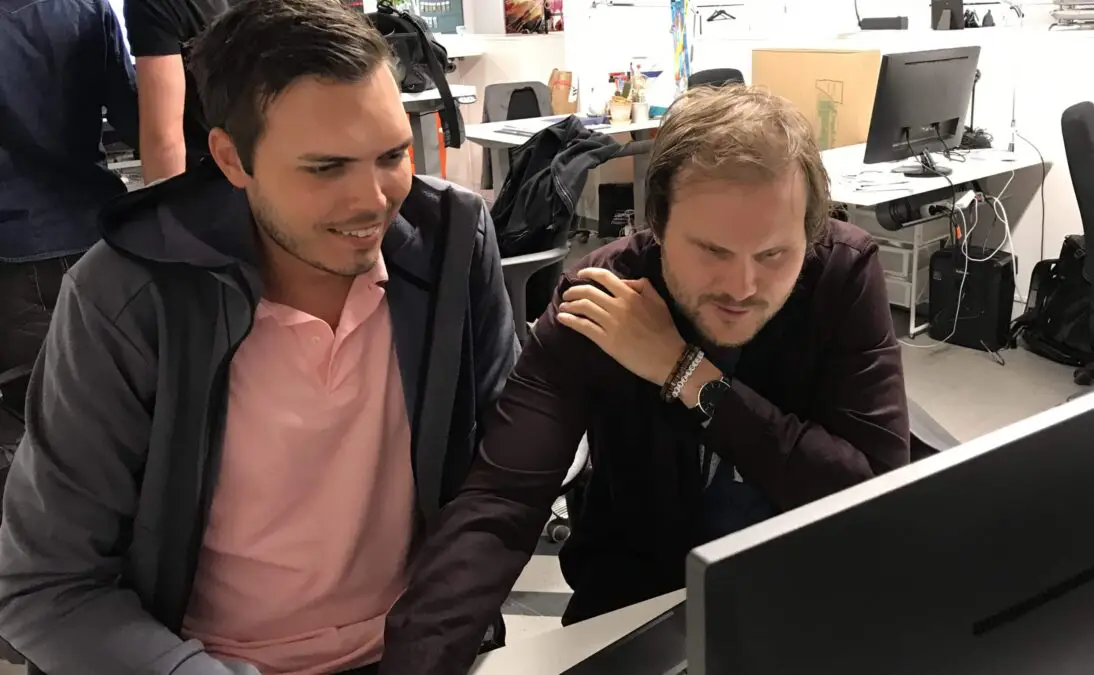 Andreas and Mattias working together in front of a screen, looking a bit puzzled.