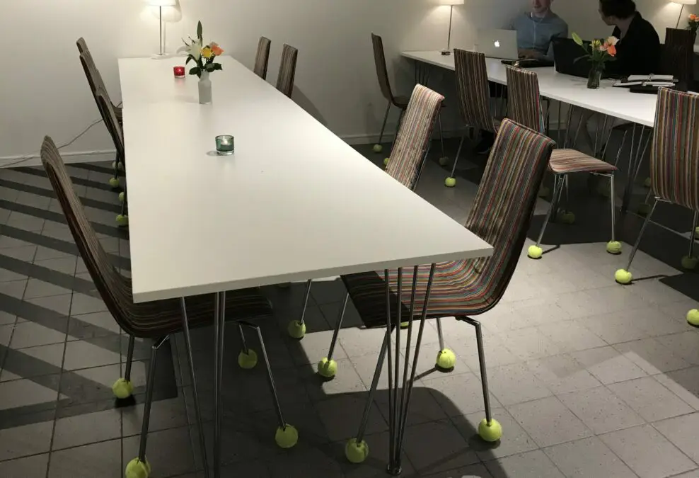 Chairs by lunch table, with tennis balls at the chairs' feet.