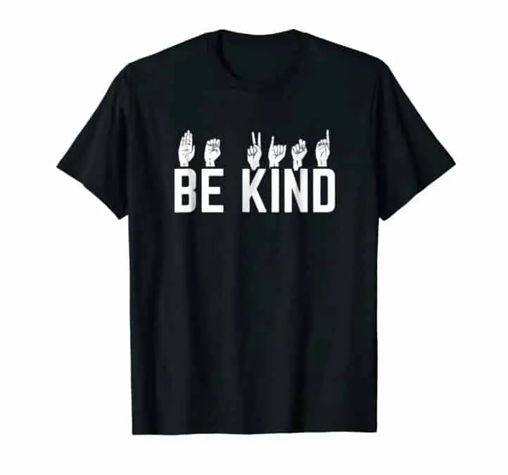 Black t-shirt with the text "Be kind" and on top of the text each letter is signed in American sign language.