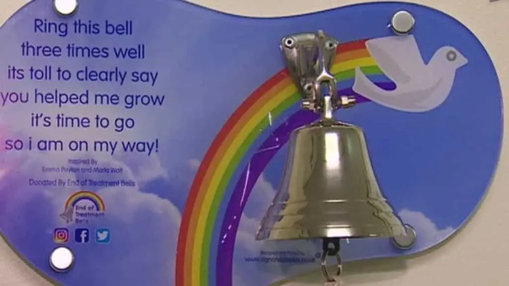 A bell with a text behind encouraging patients to ring it three times when treatment is over. 