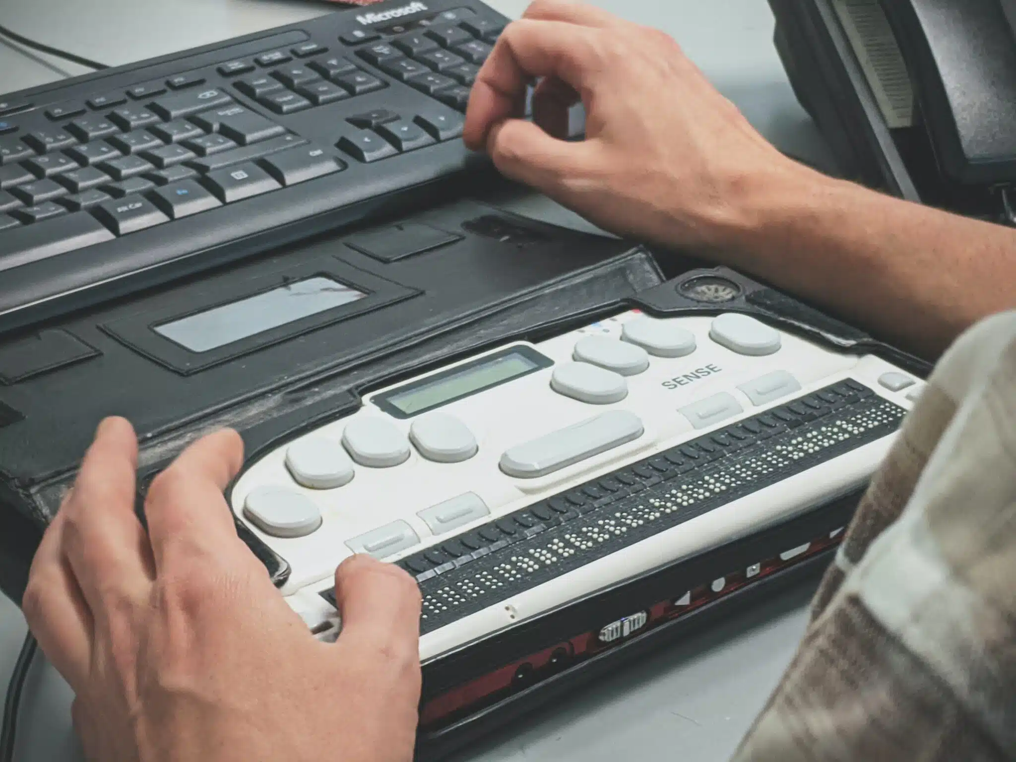 Fingers on a braille display.